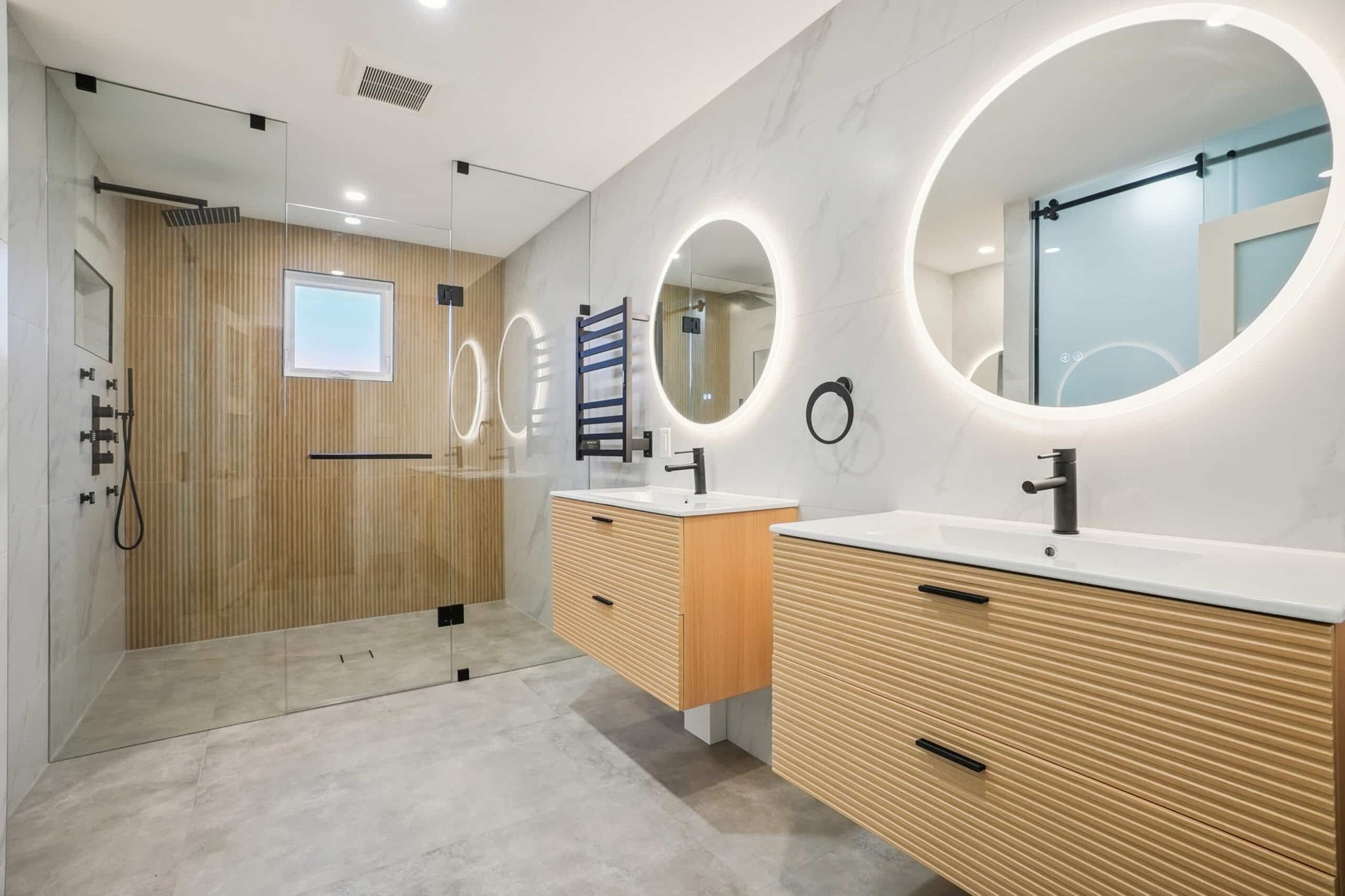 Luxury marble bathroom with freestanding tub and glass shower